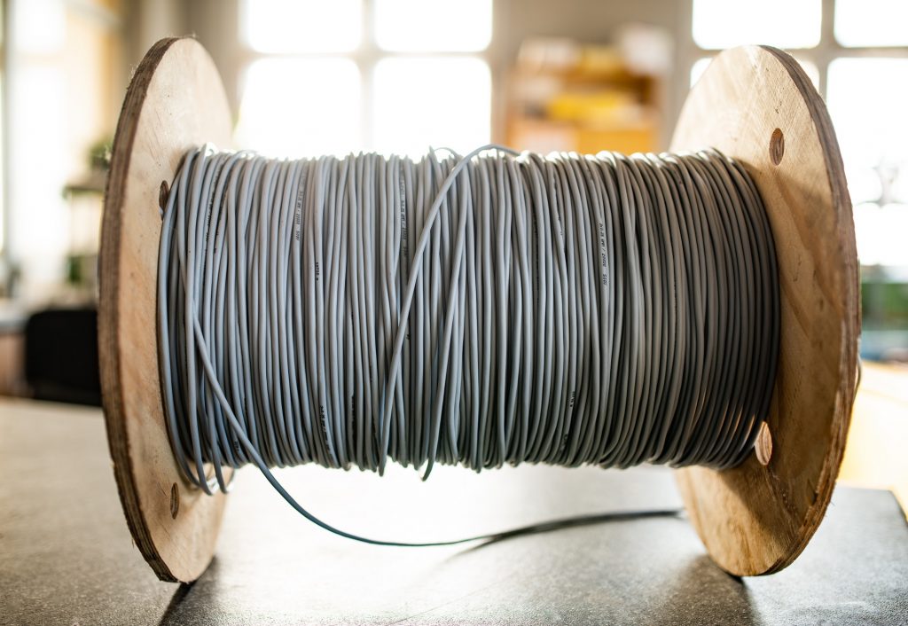 Giant skein of gray wires on a reel in manufacture